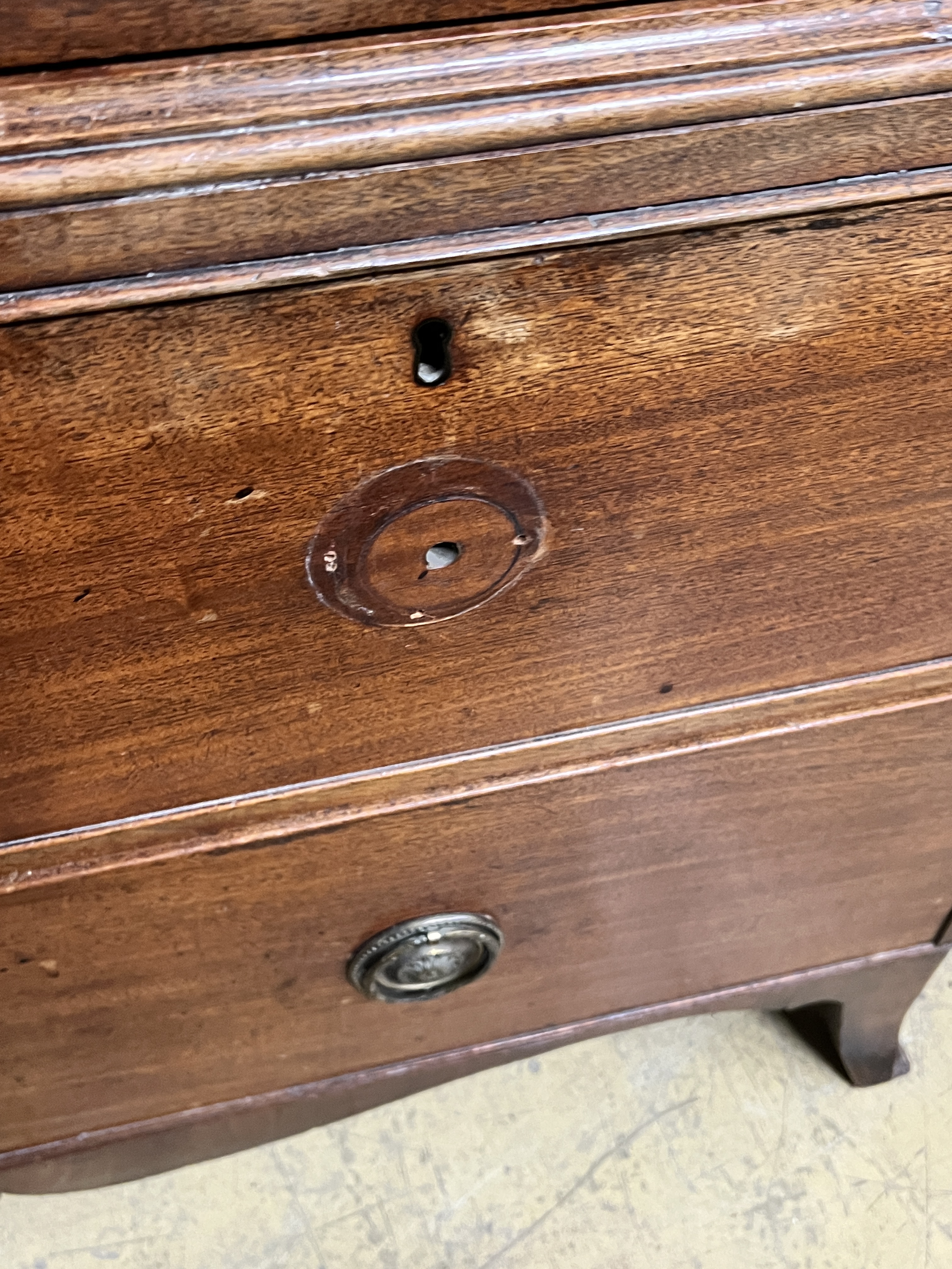 A George III mahogany linen press converted to a hanging wardrobe with part dummy drawer front, width 127cm, depth 54cm, height 178cm